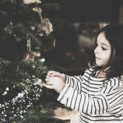 Little girl decorating tree