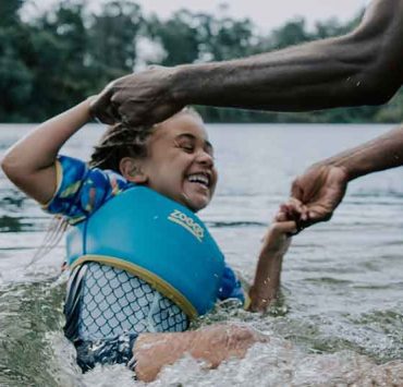 little girl swimming in lake