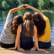 Three girls sitting on dock
