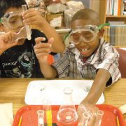 Two young boys doing science experiment in lab