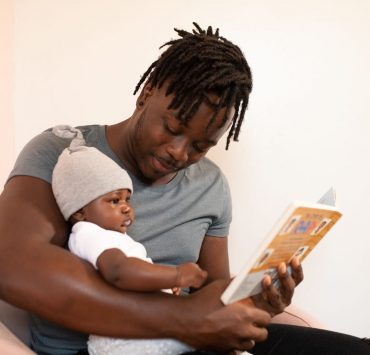 Father reading book to baby