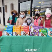 Group of Girl Scouts selling cookies outdoors