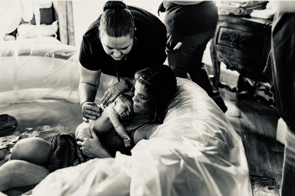 newborn baby with mother after water birth experience